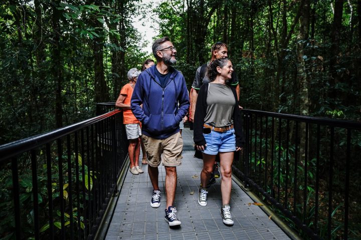 a group of people standing on a bridge